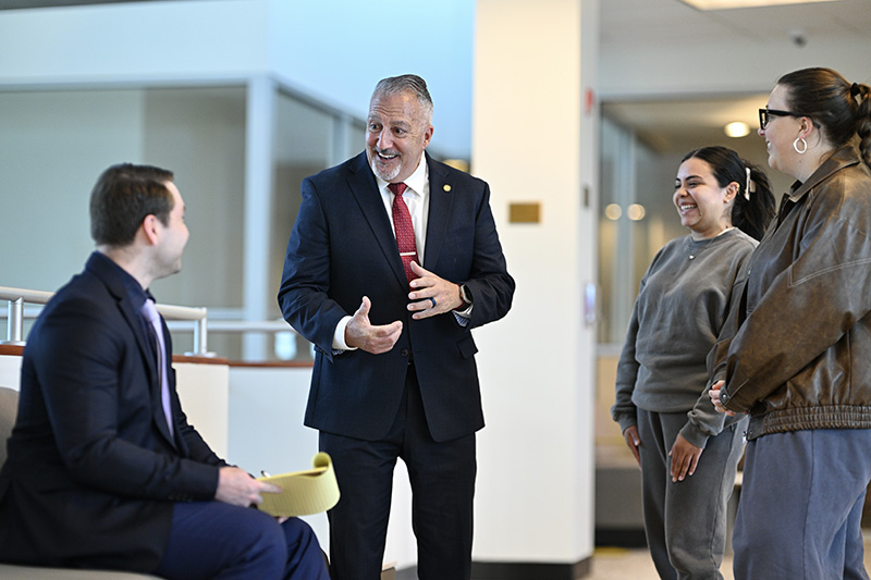 Asst. Dean for Career Services chatting with law students.
